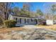 Ranch house with gray brick exterior and a large yard at 8661 Chestnut Ln, Lithia Springs, GA 30122