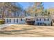 Gray brick ranch house with a landscaped yard and driveway at 8661 Chestnut Ln, Lithia Springs, GA 30122