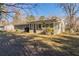 Rear view of a ranch home showcasing a large covered porch at 8661 Chestnut Ln, Lithia Springs, GA 30122