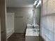 Bathroom with double vanity, bathtub, and window at 1654 Tree Line Rd, Lithonia, GA 30058
