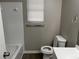 Bathroom with white tile shower, toilet, and vanity at 1654 Tree Line Rd, Lithonia, GA 30058