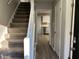 Carpeted stairs in the entryway lead upstairs and to the kitchen and living room at 1654 Tree Line Rd, Lithonia, GA 30058