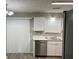 Bright kitchen with white cabinets, stainless steel appliances, and wood-look flooring at 1654 Tree Line Rd, Lithonia, GA 30058