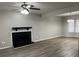 Living room with ceiling fan, fireplace, and wood-look flooring at 1654 Tree Line Rd, Lithonia, GA 30058