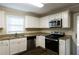 Modern kitchen with stainless steel appliances and granite countertops at 4731 Kings Hwy, Douglasville, GA 30135