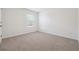 Well-lit bedroom featuring carpeted floors and a large window at 733 Millwood Dr, Dacula, GA 30019