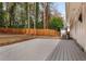 Spacious backyard deck with a wooden fence, fire pit area, and string lights at 2590 Rolling View Se Dr, Smyrna, GA 30080