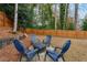 Cozy patio with firepit and four blue chairs at 2590 Rolling View Se Dr, Smyrna, GA 30080