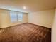 Spacious bedroom with two windows and carpeted flooring at 7709 Sudbury Cir, Covington, GA 30014