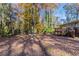 Large backyard with mature trees and leaf covered ground at 2329 Meadowlane Sw Dr, Atlanta, GA 30311