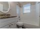 Bathroom with shower/tub combo, granite countertop and white tile at 2329 Meadowlane Sw Dr, Atlanta, GA 30311