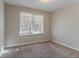 Well-lit bedroom with a large window and neutral colored carpet at 2329 Meadowlane Sw Dr, Atlanta, GA 30311