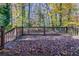 Wooden deck overlooking a wooded backyard with autumn leaves at 2329 Meadowlane Sw Dr, Atlanta, GA 30311