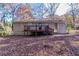 Ranch home with deck and storage building, surrounded by mature trees at 2329 Meadowlane Sw Dr, Atlanta, GA 30311
