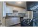 Modern kitchen with white shaker cabinets, granite countertops, and stainless steel appliances at 2329 Meadowlane Sw Dr, Atlanta, GA 30311