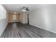 Spacious living room with dark gray vinyl flooring, neutral walls, and a ceiling fan at 2329 Meadowlane Sw Dr, Atlanta, GA 30311