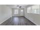 Spacious living room with dark gray vinyl flooring, neutral walls, and a ceiling fan at 2329 Meadowlane Sw Dr, Atlanta, GA 30311
