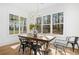 Bright dining room with a rustic wooden table and large windows at 2216A E Cherokee Dr, Woodstock, GA 30115