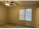 Spacious bedroom with ceiling fan and large window at 6268 Marbut Farms Trl, Lithonia, GA 30058