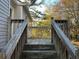 Wooden deck stairs leading to a backyard with trees and landscaping at 6268 Marbut Farms Trl, Lithonia, GA 30058