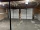 Unfinished two-car garage with concrete floor and shelving at 6268 Marbut Farms Trl, Lithonia, GA 30058