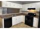 Kitchen featuring white cabinets, black appliances, and granite countertops at 6268 Marbut Farms Trl, Lithonia, GA 30058