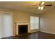 Living room with fireplace, dark flooring, and a ceiling fan at 6268 Marbut Farms Trl, Lithonia, GA 30058