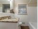 Clean bathroom with granite countertop and white tile at 2836 Hedgewood Nw Dr, Atlanta, GA 30311