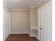 Simple bedroom with wood-paneled walls and hardwood floors at 2836 Hedgewood Nw Dr, Atlanta, GA 30311