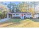 Charming ranch home with red door and well-manicured lawn at 2836 Hedgewood Nw Dr, Atlanta, GA 30311