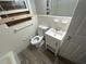 Updated bathroom with toilet and vanity, wood-look floors at 4887 Glenwood Rd, Decatur, GA 30035