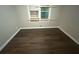 Spacious bedroom with dark wood-look floors and fresh paint at 4887 Glenwood Rd, Decatur, GA 30035