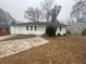 White Ranch home with a spacious yard and driveway at 4887 Glenwood Rd, Decatur, GA 30035