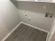 Small laundry area with vinyl flooring and hookups for washer and dryer at 4887 Glenwood Rd, Decatur, GA 30035