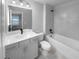 Clean bathroom with a tub and gray tile at 422 Mcdaniel Pl, Canton, GA 30115