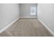 Spacious bedroom with neutral carpeting and large window at 422 Mcdaniel Pl, Canton, GA 30115