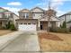 Two-story home with stone and siding exterior, two-car garage at 422 Mcdaniel Pl, Canton, GA 30115