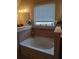 Relaxing bathroom with soaking tub and tile surround at 2513 Colin Pl, Mcdonough, GA 30253