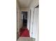 Long hallway with multiple doors and a red carpet runner at 2513 Colin Pl, Mcdonough, GA 30253