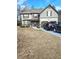 Two-story house with a tan and gray exterior, two-car garage, and landscaping at 2513 Colin Pl, Mcdonough, GA 30253