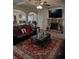 Spacious living room with fireplace, large TV, and leather sofas at 2513 Colin Pl, Mcdonough, GA 30253