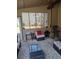 Relaxing screened porch with wicker furniture and a glass-top coffee table at 2513 Colin Pl, Mcdonough, GA 30253