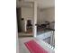 Upper hallway with carpet, red runner, and wrought iron railing at 2513 Colin Pl, Mcdonough, GA 30253