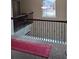 Upper hallway with carpet, red runner, and wrought iron railing at 2513 Colin Pl, Mcdonough, GA 30253