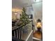 Upper level landing with a Christmas tree and view of the living room at 1709 Waters Edge Trl, Roswell, GA 30075