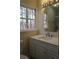 Bathroom with white vanity, quartz countertop and large mirror at 6076 Belle Meade Dr, Villa Rica, GA 30180