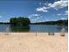 Sandy beach with lifeguard stands and picnic tables at 6076 Belle Meade Dr, Villa Rica, GA 30180