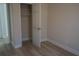 Well-lit bedroom with wood-look flooring and closet at 6076 Belle Meade Dr, Villa Rica, GA 30180
