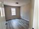 Bright bedroom with wood-look flooring and a window at 6076 Belle Meade Dr, Villa Rica, GA 30180