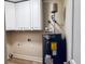 Laundry room with white cabinets and new water heater at 6076 Belle Meade Dr, Villa Rica, GA 30180